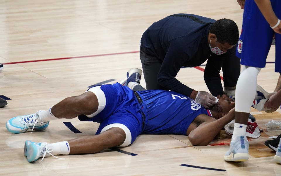 Los Angeles Clippers forward Kawhi Leonard lies on the court after suffering an injury during the second half of the team's NBA basketball game against the Denver Nuggets on Friday, Dec. 25, 2020, in Denver. (AP Photo/David Zalubowski)