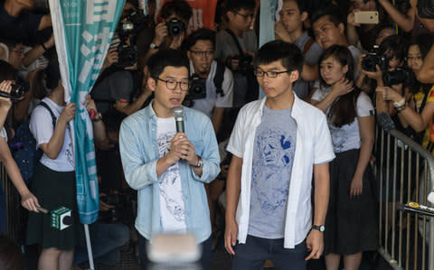 Student pro-democracy activists Nathan Law and Joshua Wong speak to the media outside Hong Kong's High Court in Hong Kong, August 17, 2017 - Credit: EPA