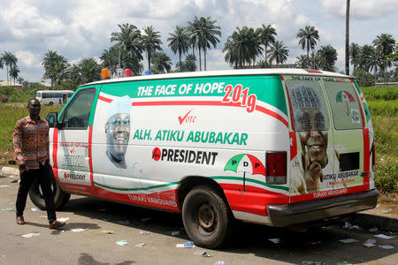 FILE PHOTO: A man walks past a van decorated with pictures of Atiku Abubakar, a former vice president, in the southern city of Port Harcourt in the Niger Delta, Nigeria October 7, 2018. REUTERS/Tife Owolabi/File Photo