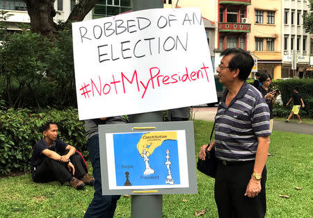 People take part in a protest against the uncontested presidential election at Hong Lim Park in Singapore September 16, 2017. REUTERS/Fathin Ungku