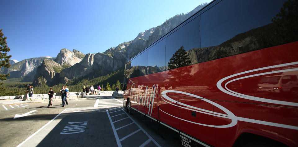 Tourists visit Tunnel View after the reopening of Yosemite National Park, Calif., Thursday, Oct. 17, 2013. Tunnel View is a scenic vista which shows off El Capitan, Half Dome and Bridalveil Fall. The park reopened Wednesday night with the end of the 16-day partial government shutdown. (AP Photo/Gary Kazanjian)