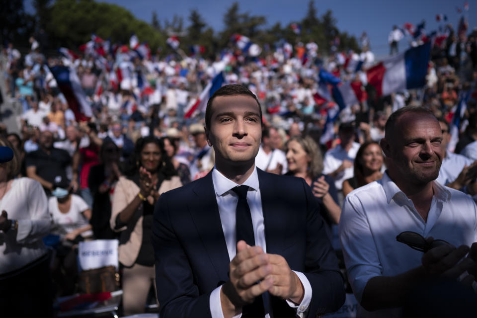 FILE - Acting head of the National Rally party Jordan Bardella applauds during a National Rally event in Frejus, France, Sunday, Sept. 12, 2021. At just 28 years old, Jordan Bardella has led the French far right to a landslide victory in the European Parliament election in June. After voters propelled Marine Le Pen's National Rally to a strong lead in the first round of national legislative elections on Sunday, Bardella has turned to rallying supporters to grant Marine Le Pen's party an absolute majority in the decisive round of voting on July 7 and make him the prime minister of France. (AP Photo/Daniel Cole, File)