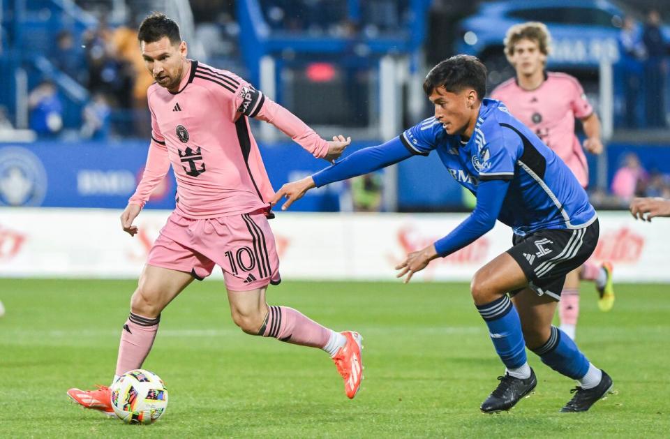 Inter Miami's Lionel Messi gets by CF Montreal's Fernando Alvarez during the first half MLS soccer action against CF Montreal in Montreal, Saturday, May 11, 2024. 