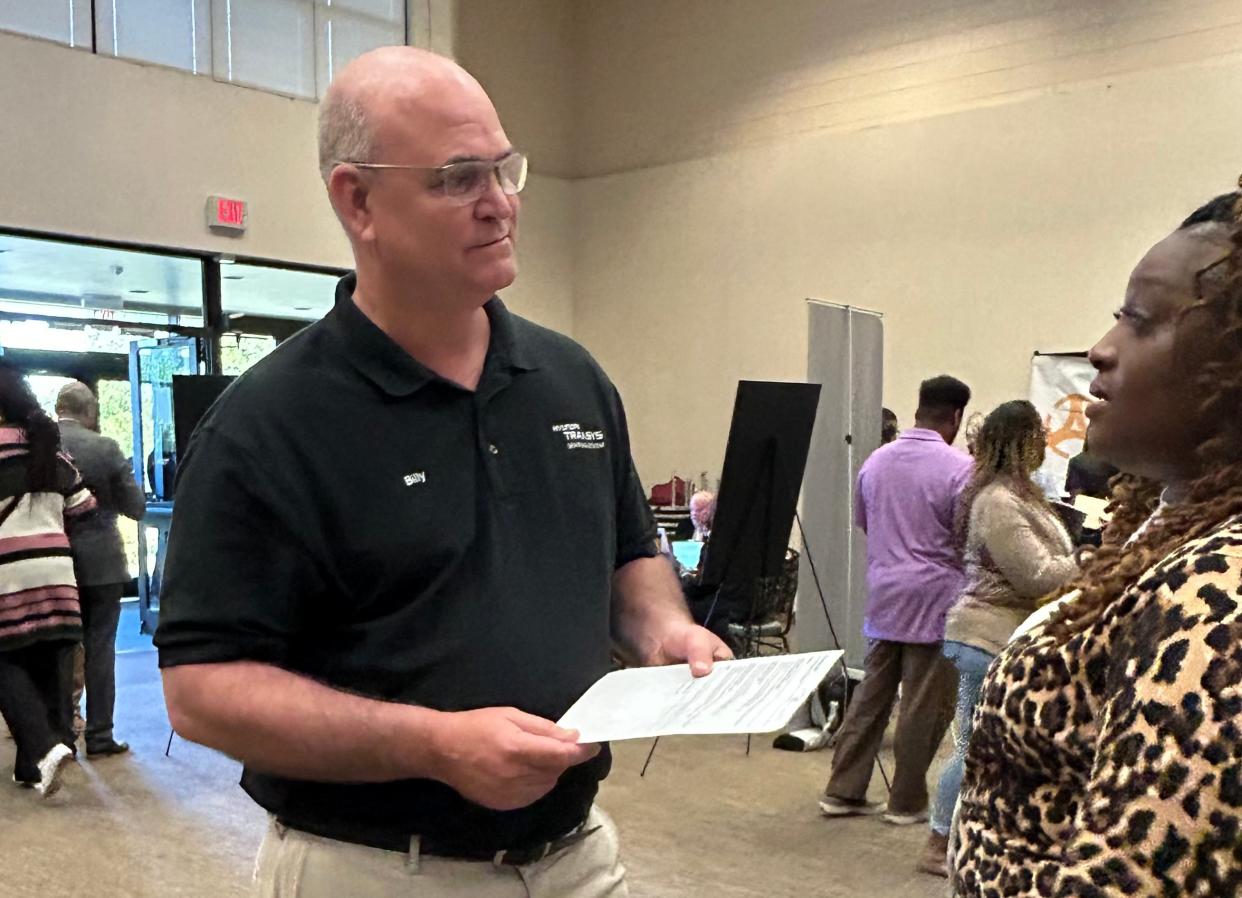 Billy Baker, Hyundai Transys COO, chats with a job seeker at Worksource Georgia's Hyundai Motor Group Metaplant America and supplier job fair on April 4, 2024 at Savannah Technical College's Eckberg Auditorium.