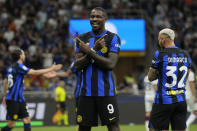 Inter Milan's Marcus Thuram, centre, celebrates after scoring his side's opening goal during the Italian Serie A soccer match between Inter Milan and Cagliari at the San Siro stadium in Milan, Italy, Sunday, April 14, 2024. (AP Photo/Antonio Calanni)