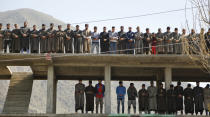 Kashmiri villagers offer prayers during the funeral of Umer Farooq, a Kashmiri civilian who was killed Sunday at Baroosa village 34 Kilometers (21 miles) northeast of Srinagar, Indian controlled Kashmir, Monday, April 10, 2017. Government forces opened fire on Sunday on crowds of people who attacked polling stations during a by-election for a vacant seat in India's Parliament, killing eight people. (AP Photo/Mukhtar Khan)