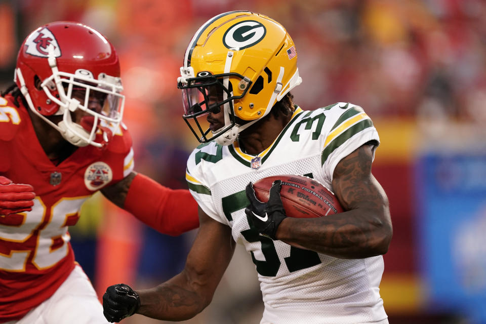 Green Bay Packers cornerback Rico Gafford (37) runs with the ball as Kansas City Chiefs safety Deon Bush (26) defends during the first half of an NFL preseason football game Thursday, Aug. 25, 2022, in Kansas City, Mo. (AP Photo/Charlie Riedel)