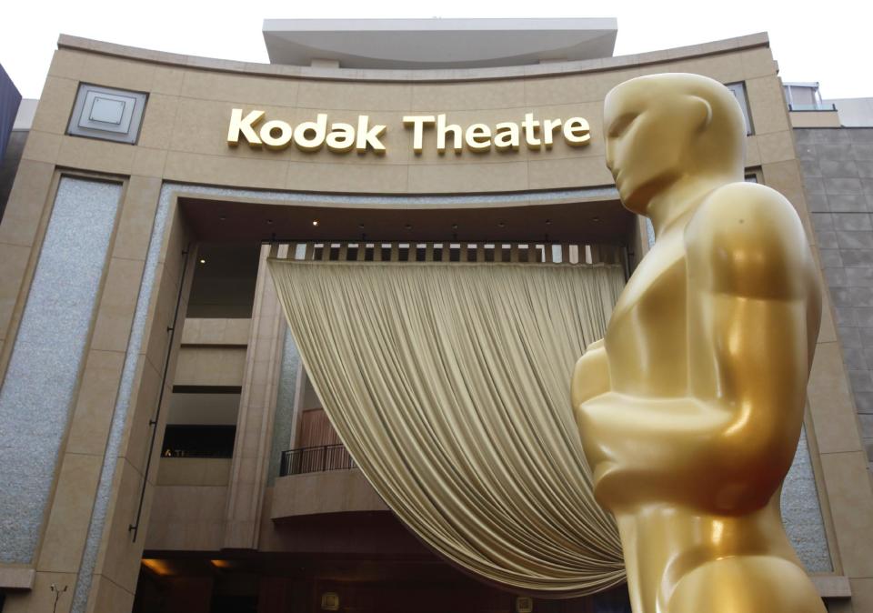 FILE - In this Feb. 26, 2012 file photo, an Oscar state is displayed outside the Kodak Theatre in preparation for the 84th Academy Awards in Los Angeles. The Academy Awards' home at Hollywood's former Kodak Theatre is being renamed the Dolby Theatre. Facility owner CIM Group on Tuesday announced a 20-year naming deal with the audio technology company Dolby Laboratories Inc. (AP Photo/Amy Sancetta, file)