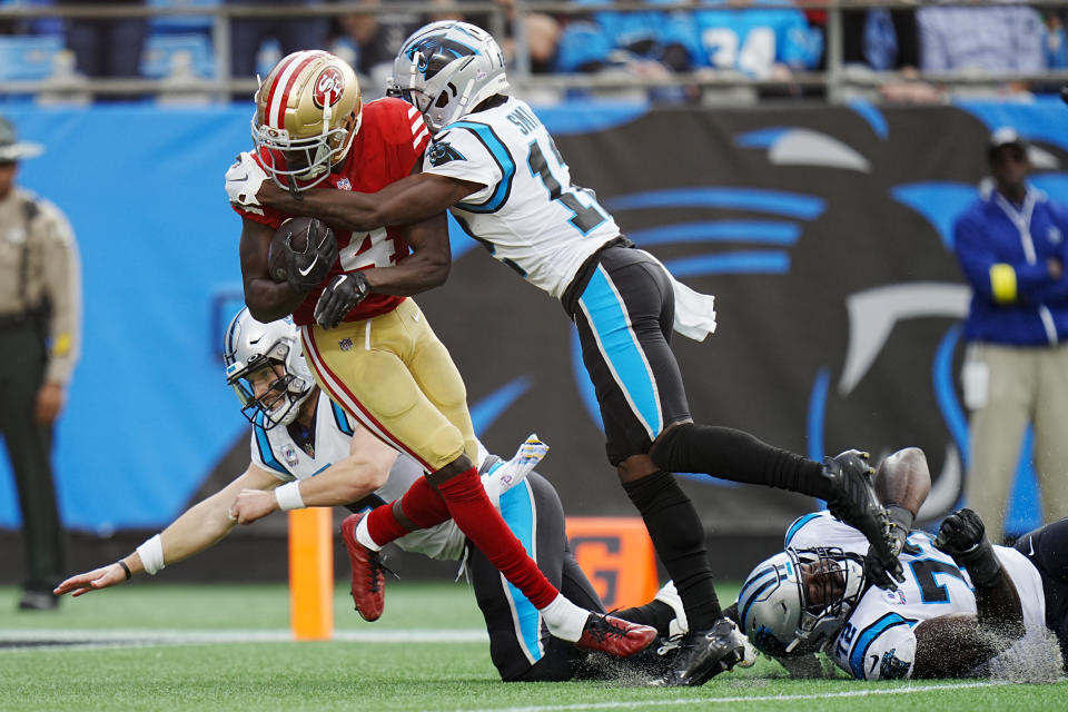 San Francisco 49ers cornerback Emmanuel Moseley scores between Carolina Panthers wide receiver Shi Smith and quarterback Baker Mayfield after an interception during the first half an NFL football game on Sunday, Oct. 9, 2022, in Charlotte, N.C. (AP Photo/Rusty Jones)