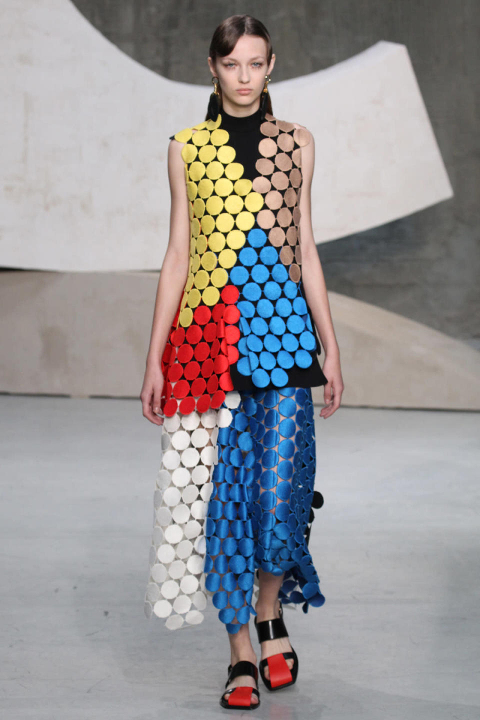 A model wears a colorblocked circle dress at Marni’s spring 2016 show in Milan. (Photo: Getty Images.)