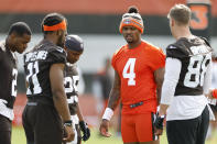 Cleveland Browns quarterback Deshaun Watson (4) talks with teammates in a huddle during NFL football practice at the team's training facility Wednesday, May 25, 2022, in Berea, Ohio. (AP Photo/Ron Schwane)