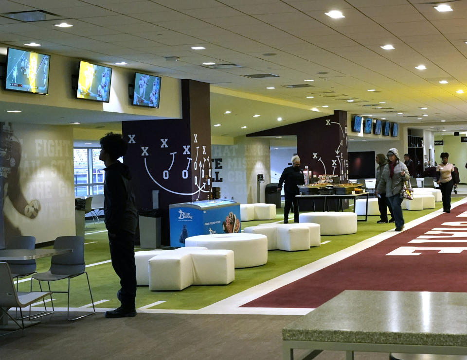 Members of Mississippi State’s Gridiron Club begin to occupy the spacious facility to view an NCAA college football game between Georgia and Mississippi State in Starkville, Miss., Saturday, Nov. 12, 2022. The end zones are not necessarily where you will find the cheap seats anymore at college football games. Several colleges have tried making end-zone seating more attractive by turning it into a premium experience that includes such amenities as access to indoor clubs with expanded food and beverage options. (AP Photo/Rogelio V. Solis)