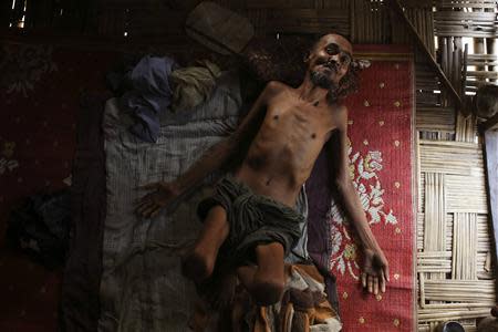 Muhammad Ali, a 54-year-old Rohingya man suffering from tuberculosis for over a year, lies inside his room at the Thet Kae Pyin camp for internally displaced people in Sittwe, Rakhine state, April 24, 2014. REUTERS/Minzayar