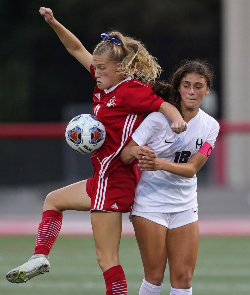 Hoban's Ariana Mahoney, right, collides with Wadsworth's Emily Nagel as they battle for the ball during the first half of a high school soccer game, Monday, Aug. 30, 2021, in Wadsworth, Ohio.