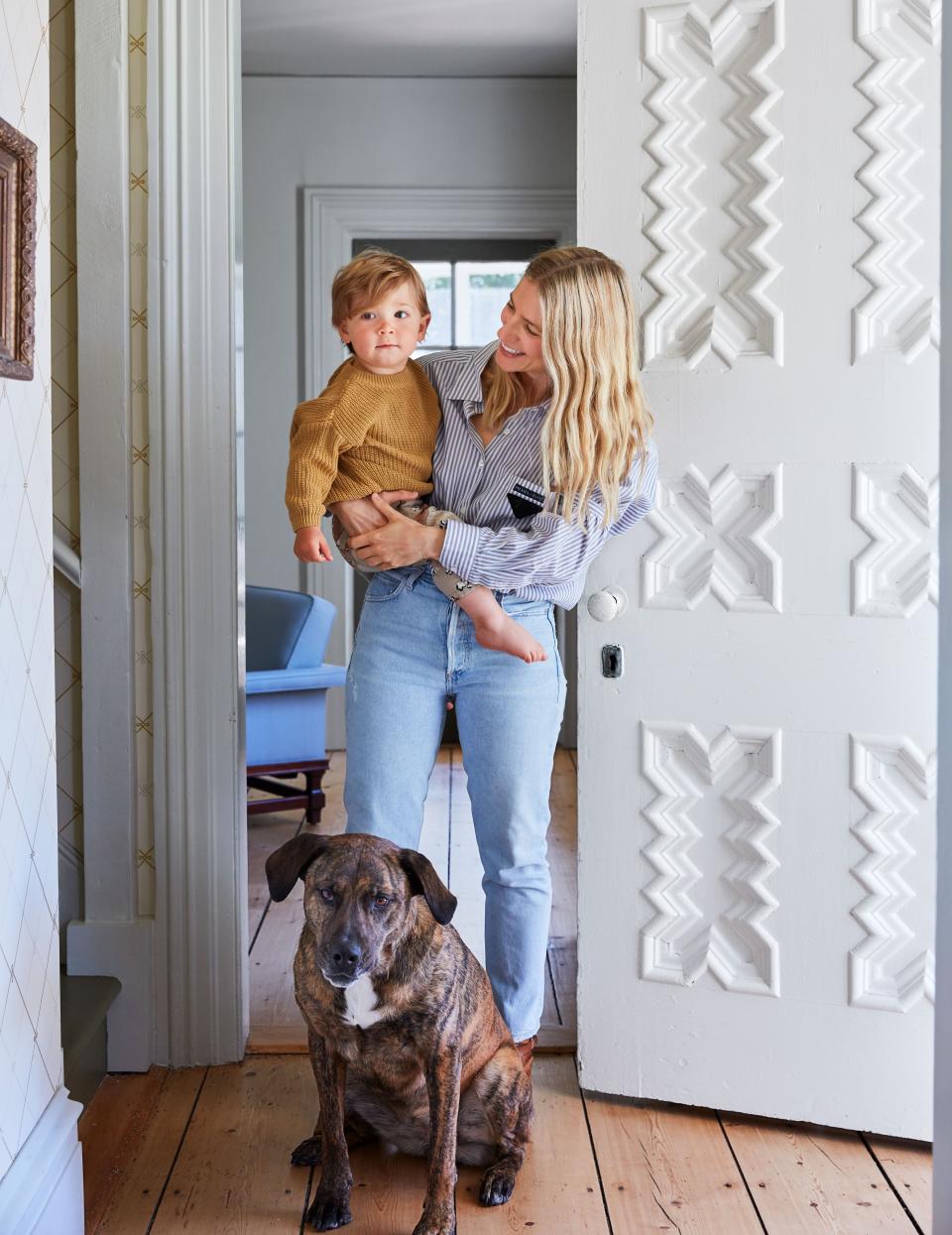 Smith and Ingy with her son, Bash, by the original front door.