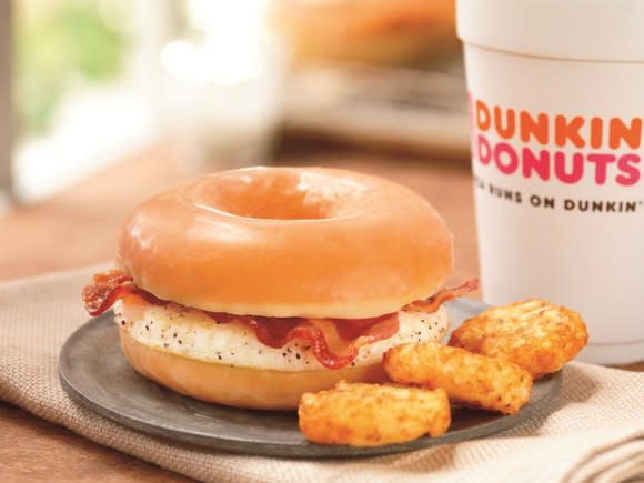 Dunkin Donuts breakfast sandwich, hash browns, and coffee
