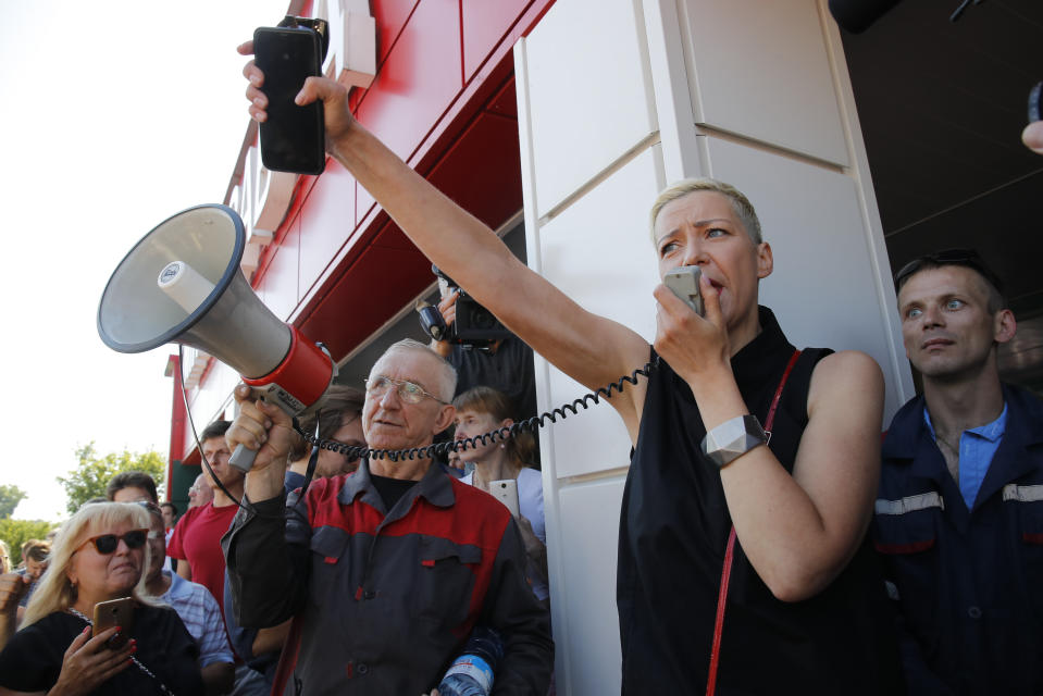 Maria Kolesnikova, Tsikhanouskaya's top associated, speaks to a crowd gathered at the Minsk Wheel Tractor Plant where Belarusian President Alexander Lukashenko addresses employees in Minsk, Belarus, Monday, Aug. 17, 2020. Several thousand plant workers took to the streets of Minsk on Monday, demanding authoritarian President Alexander Lukashenko to resign in a ninth straight day of protesting against the results of an election that extended his 26-year rule. (AP Photo/Dmitri Lovetsky)