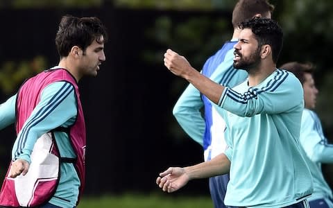 Chelsea's Brazilian-born Spanish striker Diego Costa (R) reacts next to Chelsea's Spanish midfielder Cesc Fabregas during a training session at Chelsea's training ground - Credit: Getty images