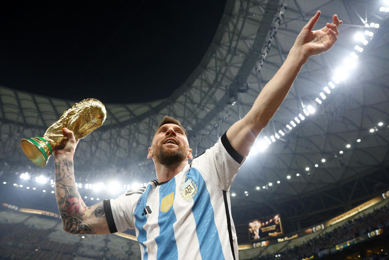 Argentina star Lionel Messi celebrates winning the World Cup.