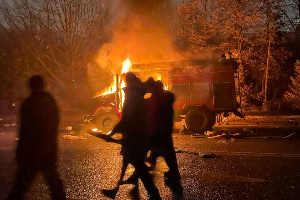 A burning car is seen by the mayors office on fire. Protests are spreading across Kazakhstan over the rising fuel prices; protesters broke into the Almaty mayors office and set it on fire