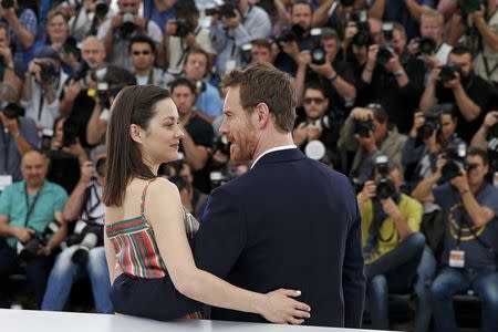 Cast members Marion Cotillard (L) and Michael Fassbender pose during a photocall for the film "Macbeth" in competition at the 68th Cannes Film Festival in Cannes, southern France, May 23, 2015. REUTERS/Benoit Tessier