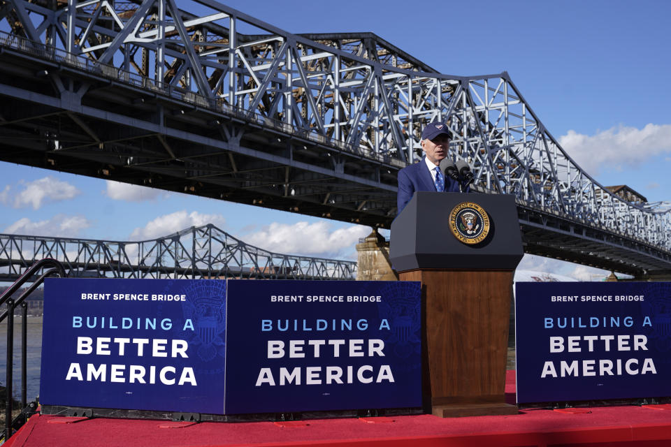 FILE - President Joe Biden speaks about his infrastructure agenda under the Clay Wade Bailey Bridge, Wednesday, Jan. 4, 2023, in Covington, Ky. Biden's infrastructure deal that was enacted in late 2021 will offer federal grants to Ohio and Kentucky to build a companion bridge that is intended to alleviate traffic on the Brent Spence Bridge, in background at left. (AP Photo/Patrick Semansky, File)