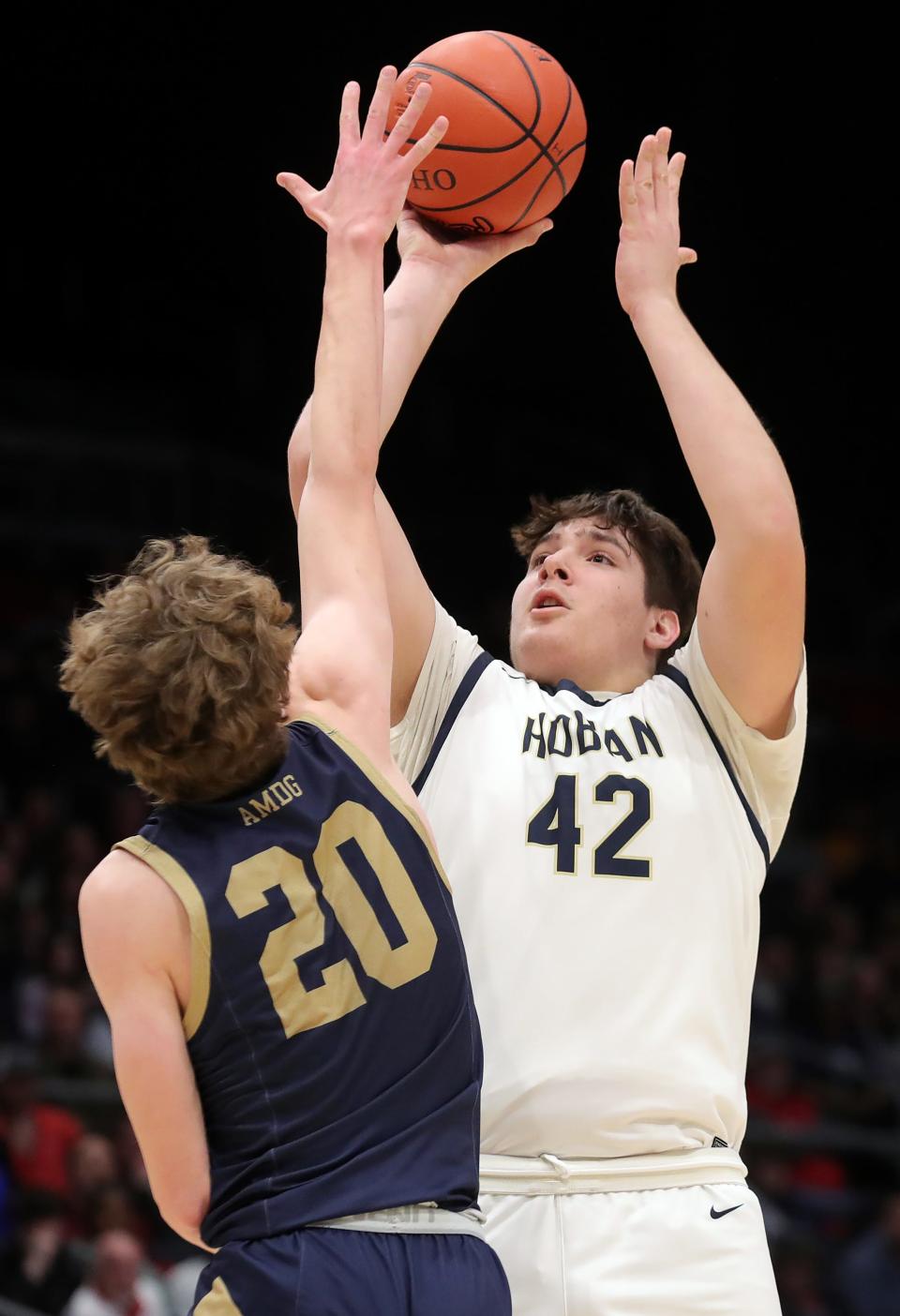 Hoban center Sam Greer, right, looks to shoot over St. John's Jesuit's Mitchell Michalak during the first half of a Division I state semifinal basketball game at UD Arena, Saturday, March 18, 2023, in Dayton, Ohio.