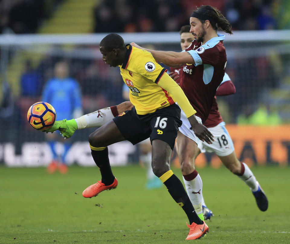 Burnley's George Boyd, right, and Watford's Abdoulaye Doucoure battle for the ball during the English Premier League soccer match at Vicarage Road, Watford, England, Saturday Feb. 4, 2017. (Nigel French/PA via AP)