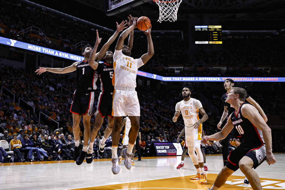 Tennessee forward Tobe Awaka (11) shoots past Georgia guard Jabri Abdur-Rahim (1) and center Frank Anselem (5) during the first half of an NCAA college basketball game Wednesday, Jan. 25, 2023, in Knoxville, Tenn. (AP Photo/Wade Payne)