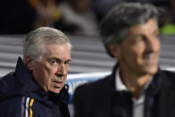 Real Madrid's head coach Carlo Ancelotti, background left, arrives for the match behind Real Sociedad's manager Imanol Alguacil at the Spanish La Liga soccer match between Real Sociedad and Real Madrid in San Sebastian, Spain, Friday, April 26, 2024. (AP Photo/Alvaro Barrientos)