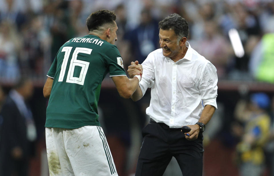 Mexico’s Hector Herrera celebrates with manager Juan Carlos Osorio after El Tri’s 1-0 World Cup win over Germany. (AP)