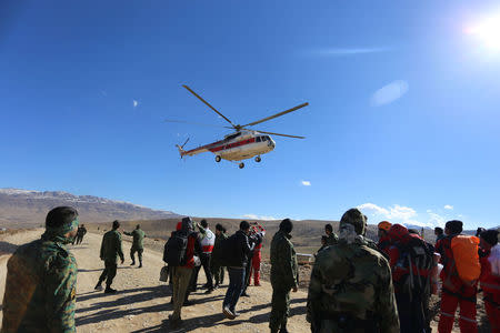 Members of emergency and rescue team search for the plane that crashed in a mountainous area of central Iran, February 19, 2018. REUTERS/Tasnim News Agency