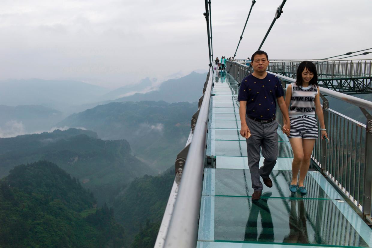 <p>File A glass-bottomed skywalk, certified as the world’s longest, at the Ordovician park in Wansheng.  Hovering more than 100 metres (328 feet) above a gaping chasm</p> (AFP via Getty Images)