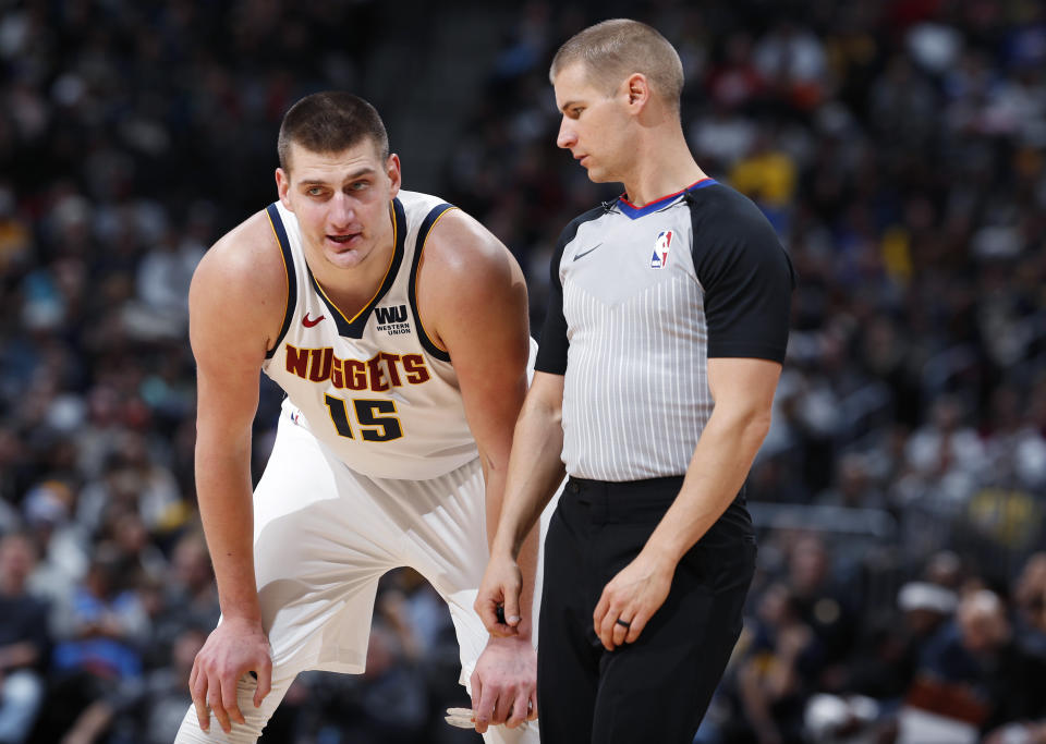 FILE - In this Tuesday, Jan. 1, 2019, file photo, Denver Nuggets center Nikola Jokic, left, confers with referee Tyler Ford during the second half of an NBA basketball game against the New York Knicks in Denver. Jokic, a 7-footer from Serbia, is leading the Nuggets to new heights so far this season with his style of play in the pivot. (AP Photo/David Zalubowski, File)