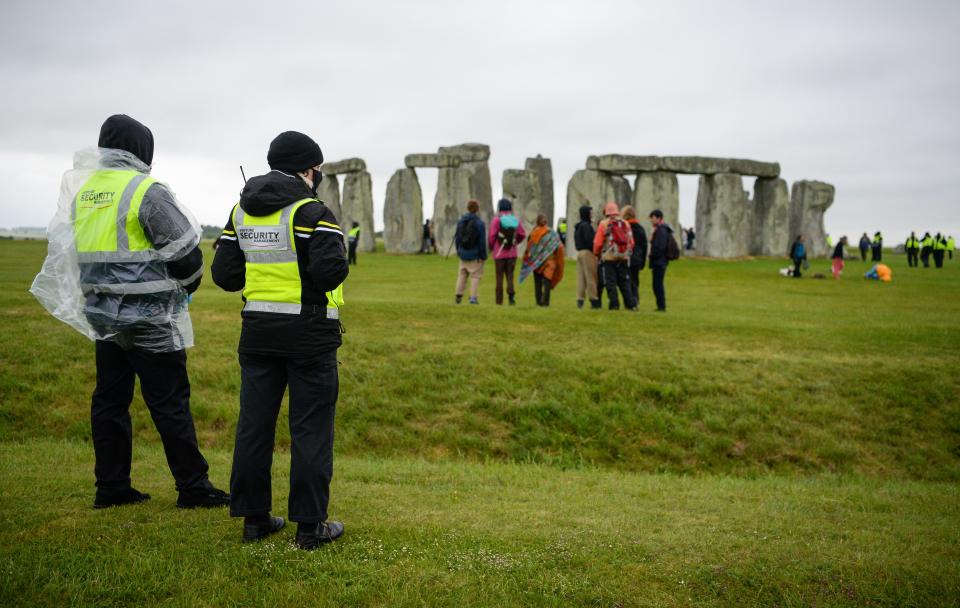 Security guards monitoring Stonehenge as hundreds descend on the closed site for the summer solstice (Getty Images)