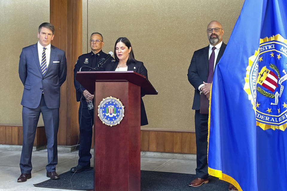 Stephanie Shark, Assistant Special Agent in Charge of the FBI Portland field office, speaks at a press conference in Portland, Ore., on Wednesday, Aug. 2, 2023, accompanied by John Casolino, left, senior assistant attorney general of the Criminal Justice Division of the Oregon Department of Justice, Klamath Falls Police Capt. Rob Reynolds, second from left, and Assistant U.S. Attorney Nathan Lichvarcik, right. The press conference was held to discuss the case of an Oregon man facing a federal interstate kidnapping charge after he posed as an undercover police officer to kidnap a woman in Seattle, drove her hundreds of miles to his home in Oregon and locked her in the cinderblock cell until she bloodied her hands breaking the door to escape. (AP Photo/Claire Rush)