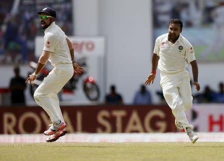India's Amit Mishra (R) celebrates with captain Virat Kohli after taking the wicket of Sri Lanka's Dinesh Chandimal (not pictured) during the fifth day of their second test cricket match in Colombo August 24, 2015. REUTERS/Dinuka Liyanawatte