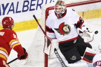 Ottawa Senators goalie Anton Forsberg, right, gives up a goal to Calgary Flames' Mikael Backlund during the second period of an NHL hockey game Sunday, May 9, 2021, in Calgary, Alberta. (Larry MacDougal/The Canadian Press via AP