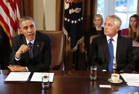 U.S. President Barack Obama (L) speaks as Secretary of Defense Chuck Hagel listens before the start of a Cabinet Meeting in the Cabinet Room at the White House in Washington, November 7, 2014. REUTERS/Larry Downing