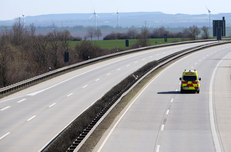 An emergency and rescue car drives on the deserted A4 highway near Erfurt, Germany, Monday, March 23, 2020, the day after the German government spoke out more restrictions to avoid the spread of the novel coronavirus. For most people, the new coronavirus causes only mild or moderate symptoms, such as fever and cough. For some, especially older adults and people with existing health problems, it can cause more severe illness, including pneumonia. (AP Photo/Jens Meyer)