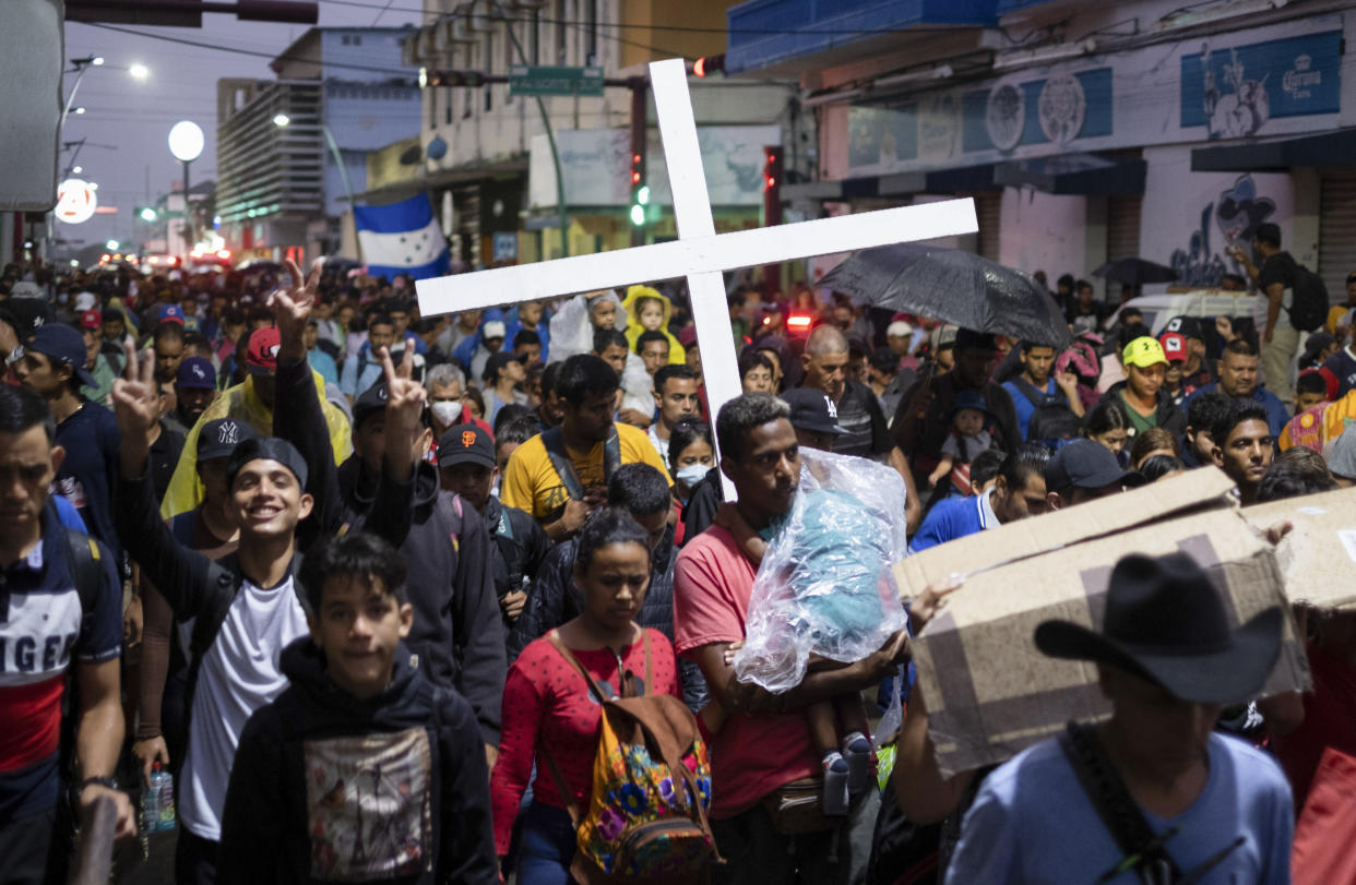 A group of migrants depart by foot the city of Tapachula in Chiapas state, Mexico, early Monday, June 6, 2022. Several thousand migrants set out walking in the rain early Monday in southern Mexico, tired of waiting to normalize their status in a region with little work still far from their ultimate goal of reaching the United States. (AP Photo/Isabel Mateos)