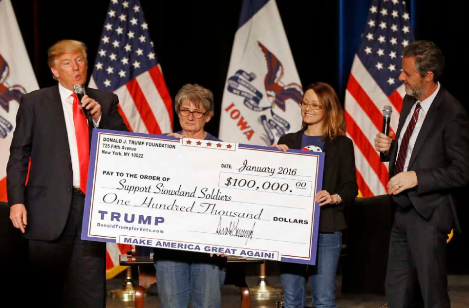 <span class="pb-caption">Donald Trump presents a check to members of Support Siouxland Soldiers during a campaign event at the Orpheum Theatre in Sioux City, Iowa, in January 2016. (Photo: Patrick Semansky/AP)</span>