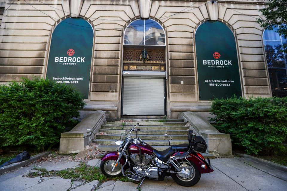 A motorcycle sits on a cracked sidewalk in front of 1300 Beaubien, the former police headquarters is owned by Bedrock and sits empty with no construction activity on Tuesday, June 11, 2019. 