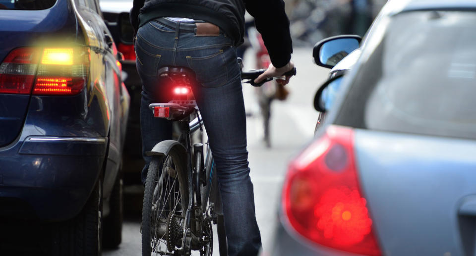 Cyclist between cars. Source: Getty Images, stock