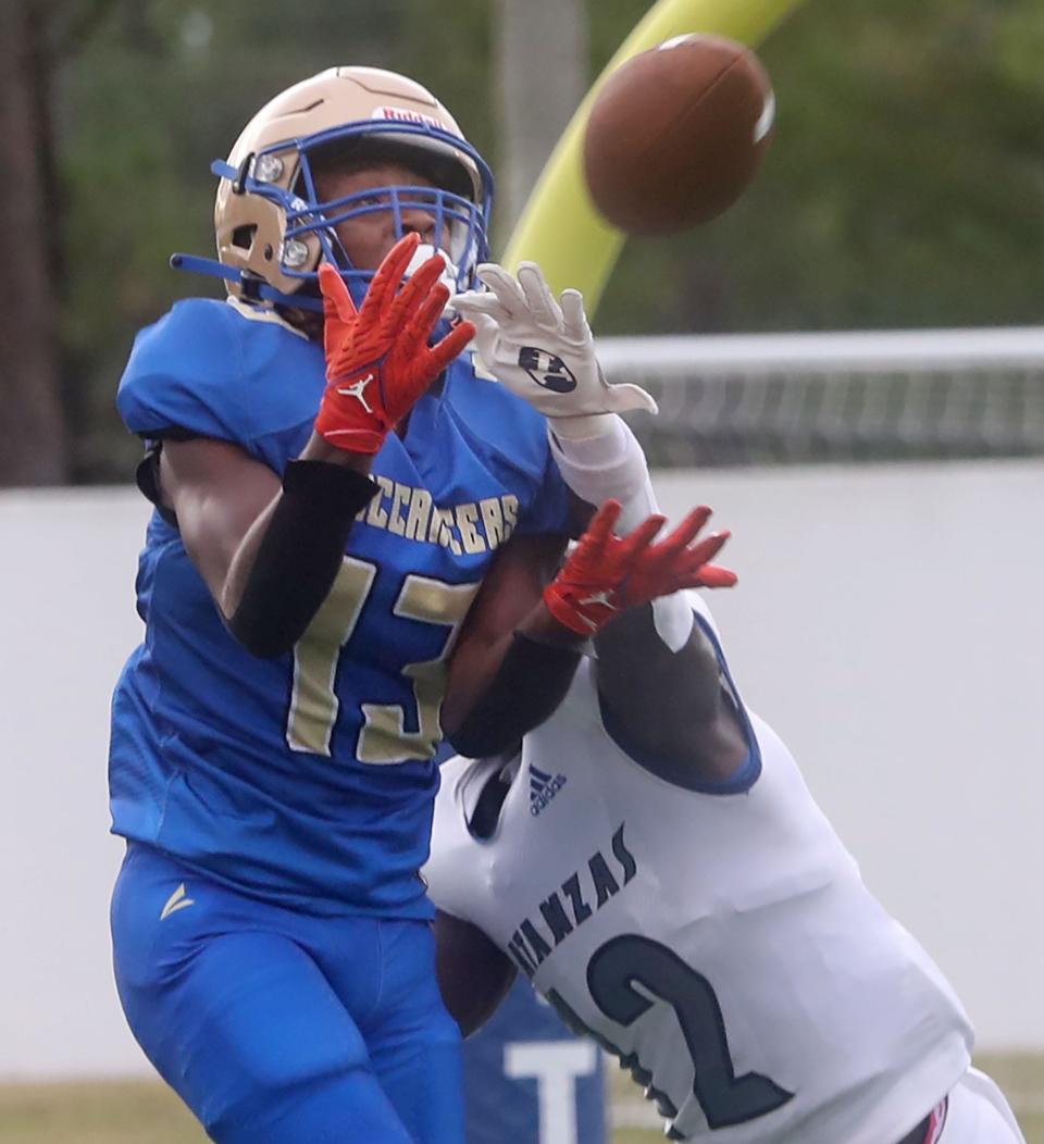 Mainland High's MarQuis McCants #13 catches a pass for a touchdown as Matanzas High Jereriah McCoy #12 tries to break up the catch, Friday Auigust 18, 2023 in Daytona Beach.