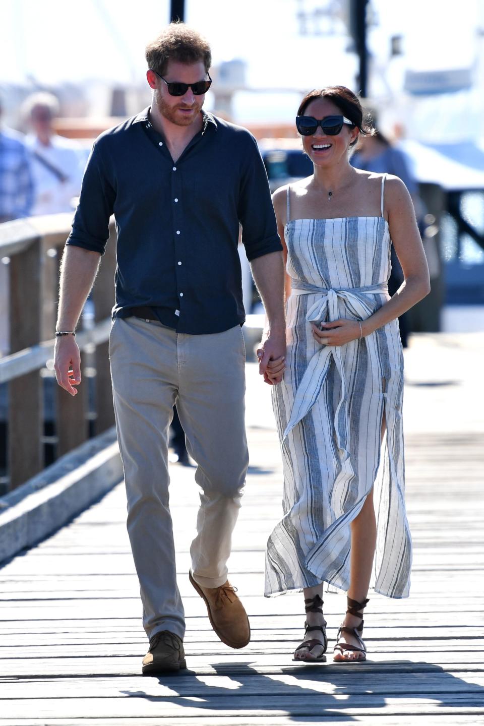 <p>On day seven of the couple’s royal tour, the Duchess took a stroll along Kingfisher Bay jetty on Fraser Island in a $218 (£167) striped sundress by sustainable US label Reformation and her favourite £277 Sarah Flint sandals. <em>[Photo: Getty]</em> </p>