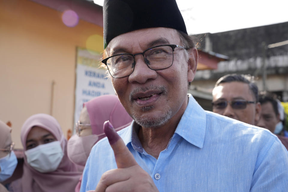 Malaysian opposition leader Anwar Ibrahim shows his inked finger after voting at a polling station in Seberang Perai, Penang state, Malaysia, Saturday, Nov. 19, 2022. Malaysians began casting ballots Saturday in a tightly contested national election that will determine whether the country's longest-ruling coalition can make a comeback after its electoral defeat four years ago. (AP Photo/Vincent Thian)