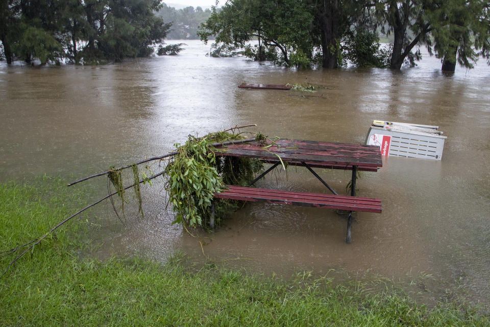Debris rests on a table on the banks of the Nepean River at Jamisontown on the western outskirts of Sydney Monday, March 22, 2021. Australia's most populous state of New South Wales has issued more evacuation orders following the worst flooding in decades. (AP Photo/Mark Baker)