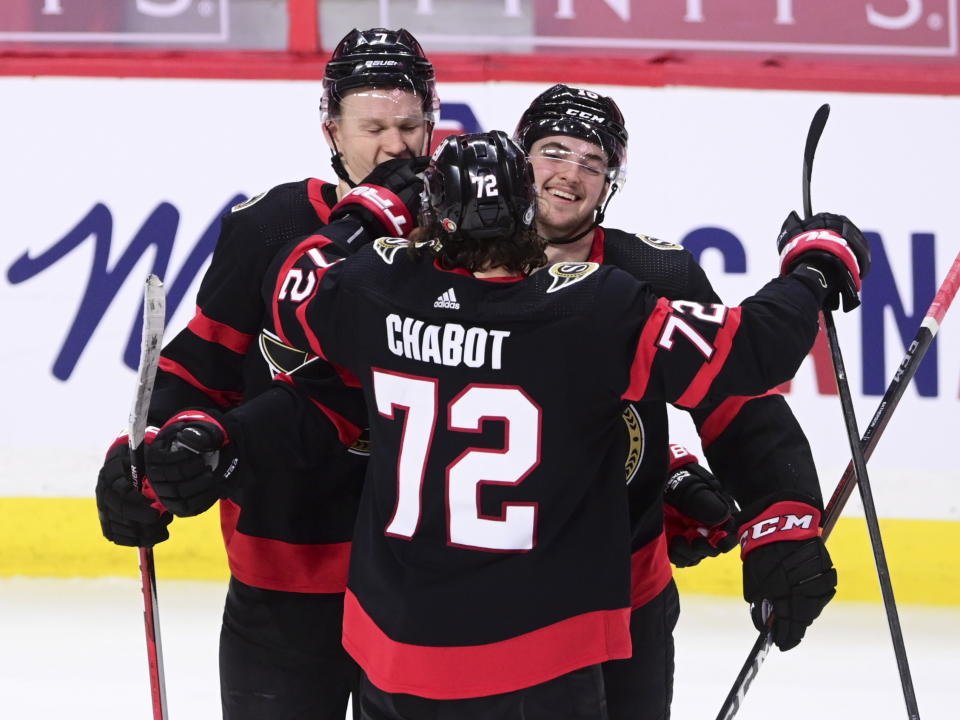 Ottawa Senators defenseman Thomas Chabot (72) and Brady Tkachuk (7) congratulate Drake Batherson (19) on his goal against the Calgary Flames during second period NHL hockey action in Ottawa on Monday, March 1, 2021. (Sean Kilpatrick/The Canadian Press via AP)