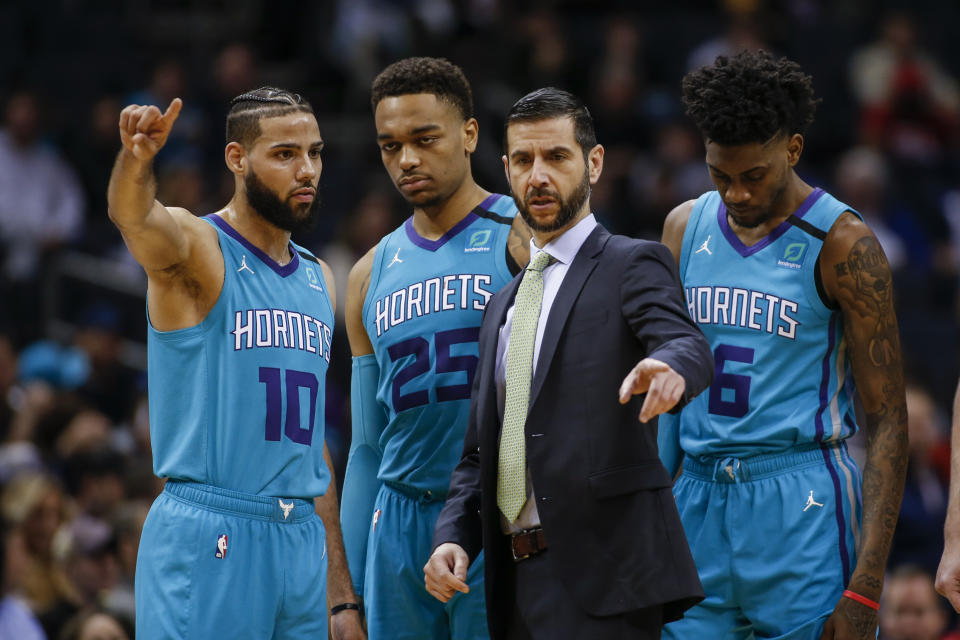 Charlotte Hornets head coach James Borrego coaches Charlotte Hornets forwards Caleb Martin (10), P.J. Washington (25) and Jalen McDaniels (6) during the first half of an NBA basketball game against the Denver Nuggets in Charlotte, N.C., Thursday, March 5, 2020. Denver won 114-112. (AP Photo/Nell Redmond)